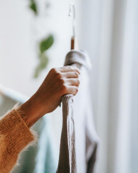 crop woman choosing apparel at home