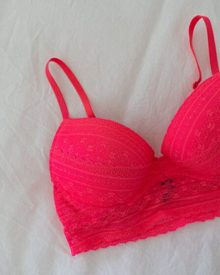 red brassiere on white cloth