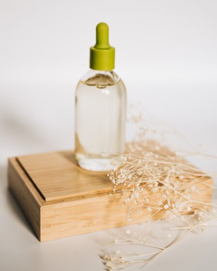 clear serum bottle on top of a wooden box