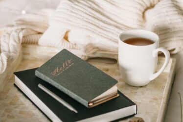 photo of cup beside books