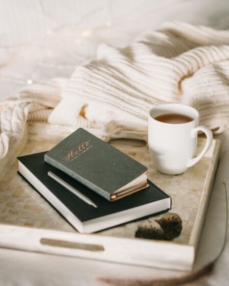 photo of cup beside books