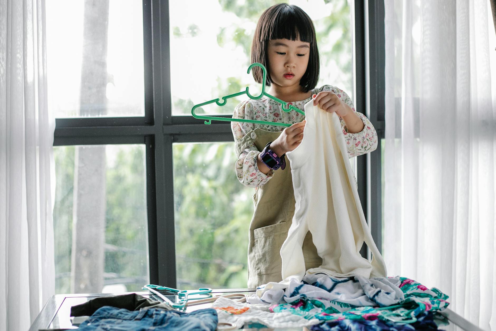 little girl doing housework in room