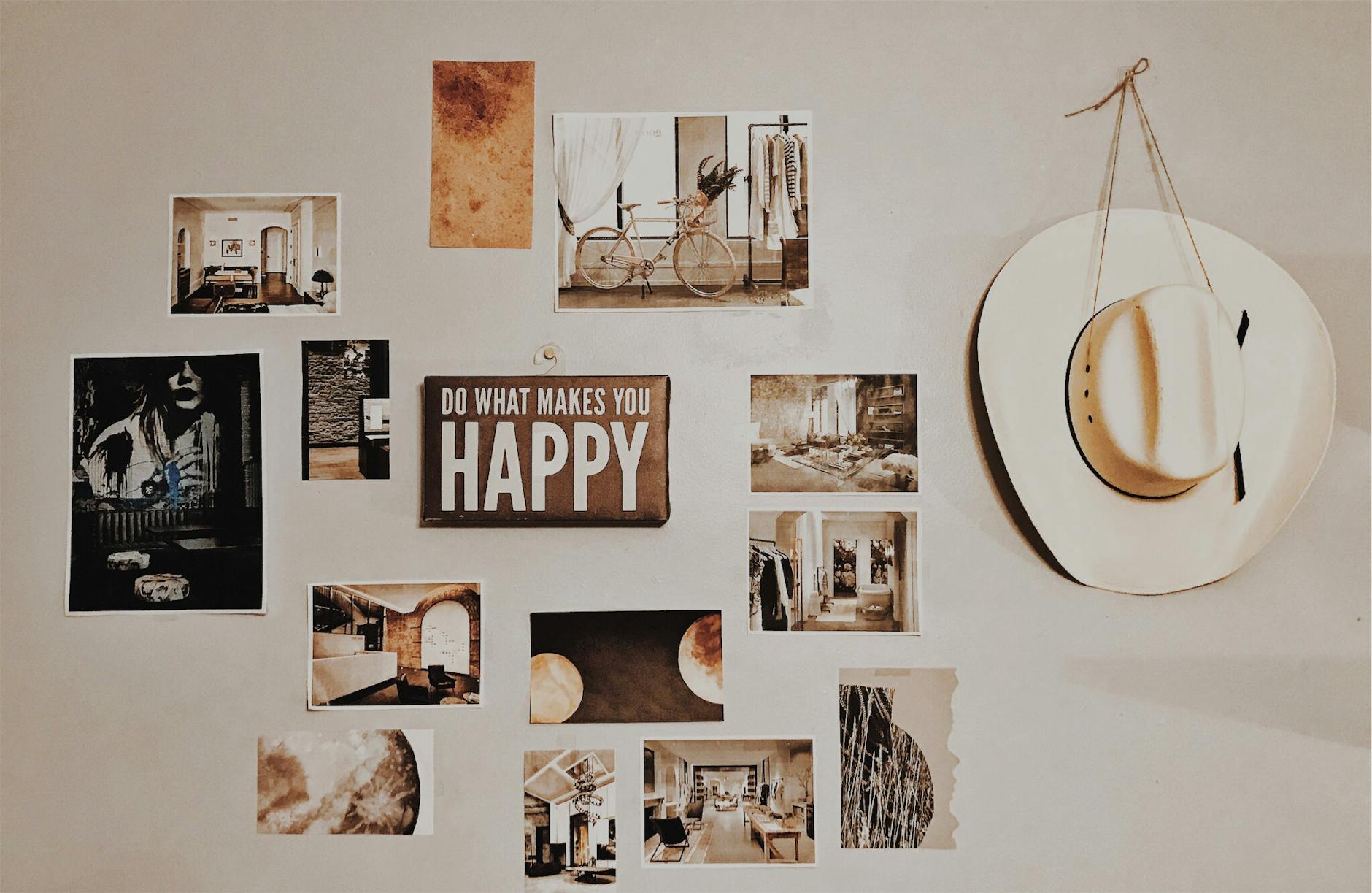 photo of brown and white photo frames hang in wall
