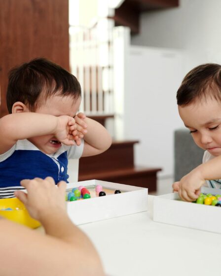 a child crying while playing with his brother