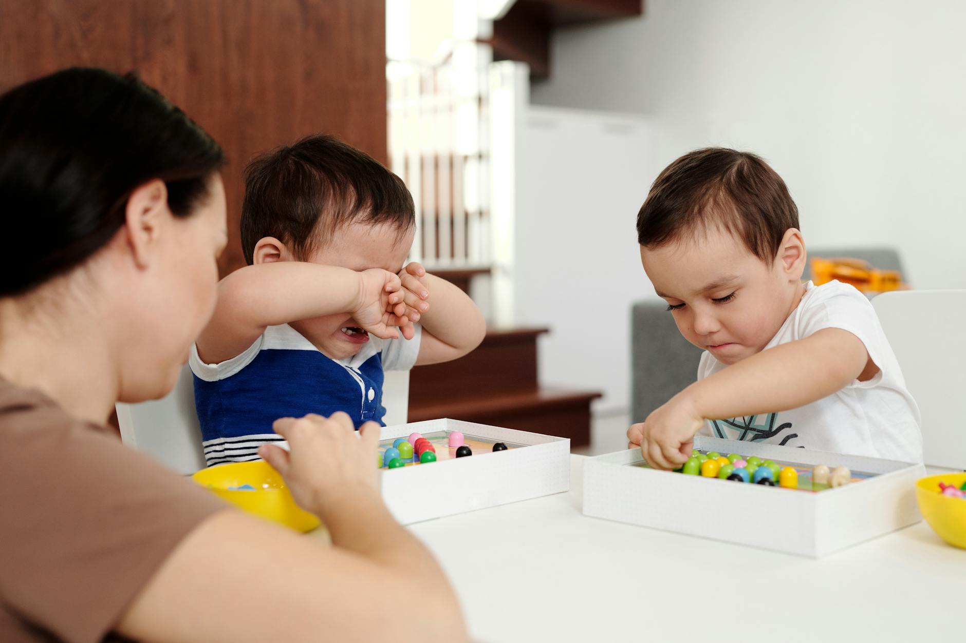 a child crying while playing with his brother