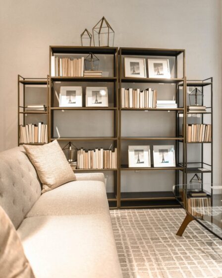 brown wooden shelf and beige fabric sofa