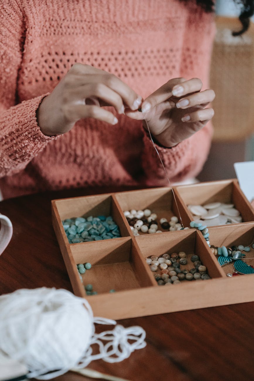 craftswoman creating handmade accessory with beads