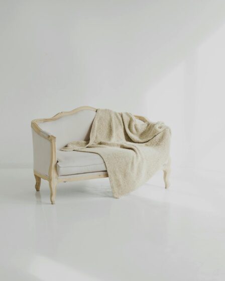 white towel on white wooden sofa