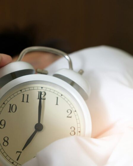 photo of person holding alarm clock