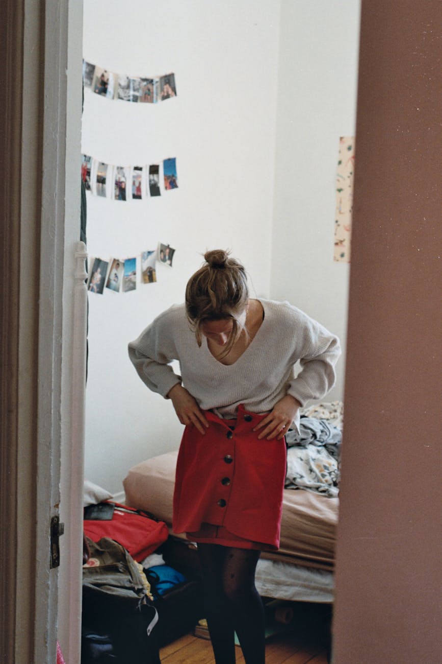 woman trying clothes in bedroom