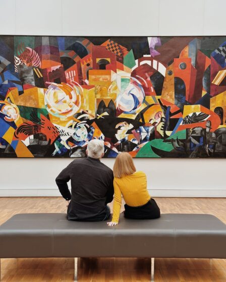 people looking at painting in art gallery