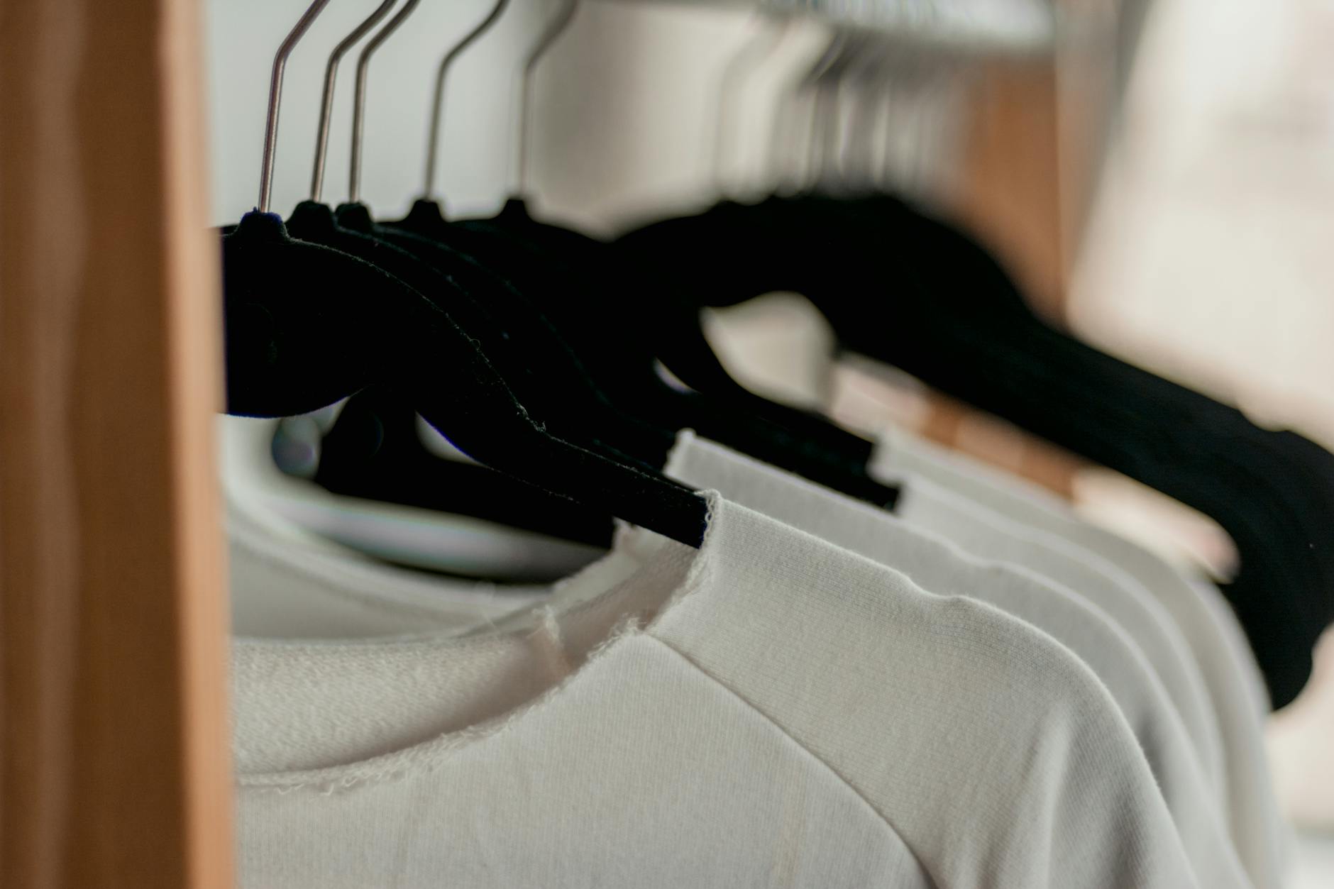 hanged white shirts on black clothes hangers