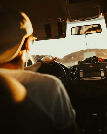 man holding the steering wheel while driving