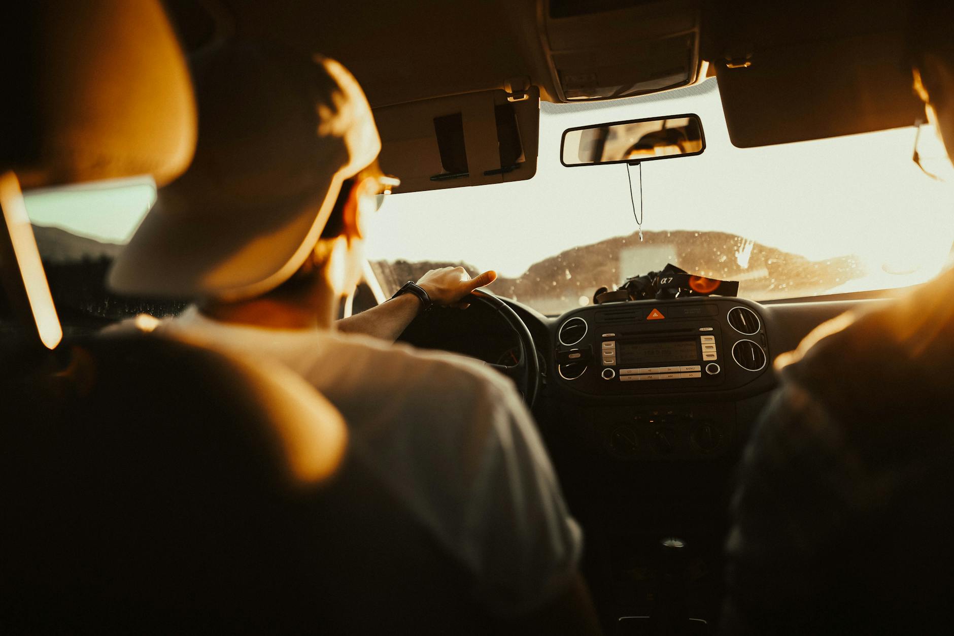 man holding the steering wheel while driving