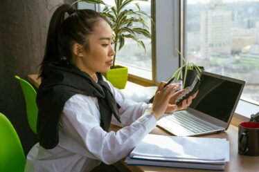 a woman computing with a calculator