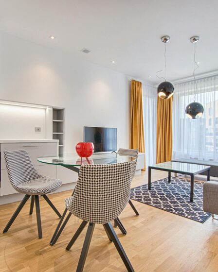 two chairs with glass table on living room near window