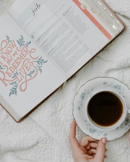 a person having coffee while reading a book