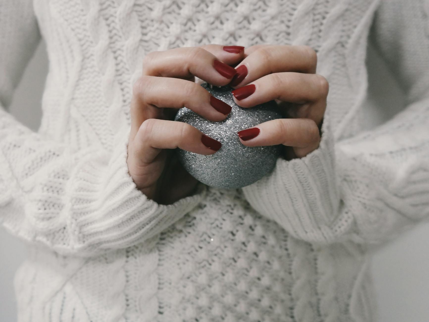 person holding gray ball