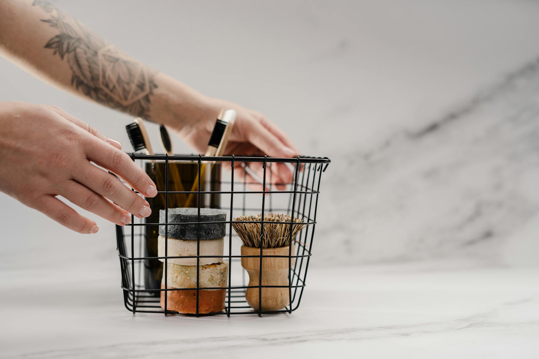 person holding stainless steel basket with brown and black metal tools