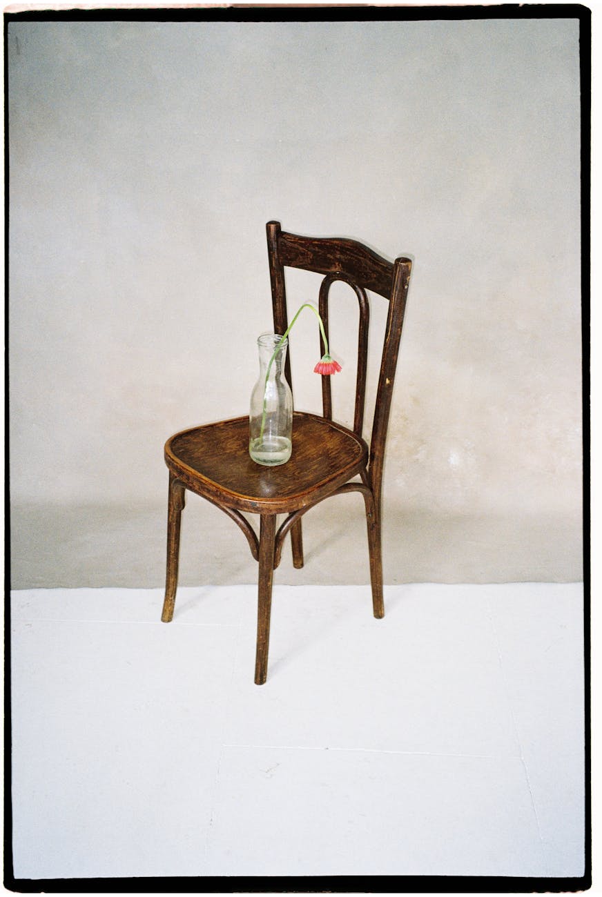 flower in bottle on chair