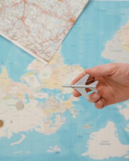 a person holding white toy airplane