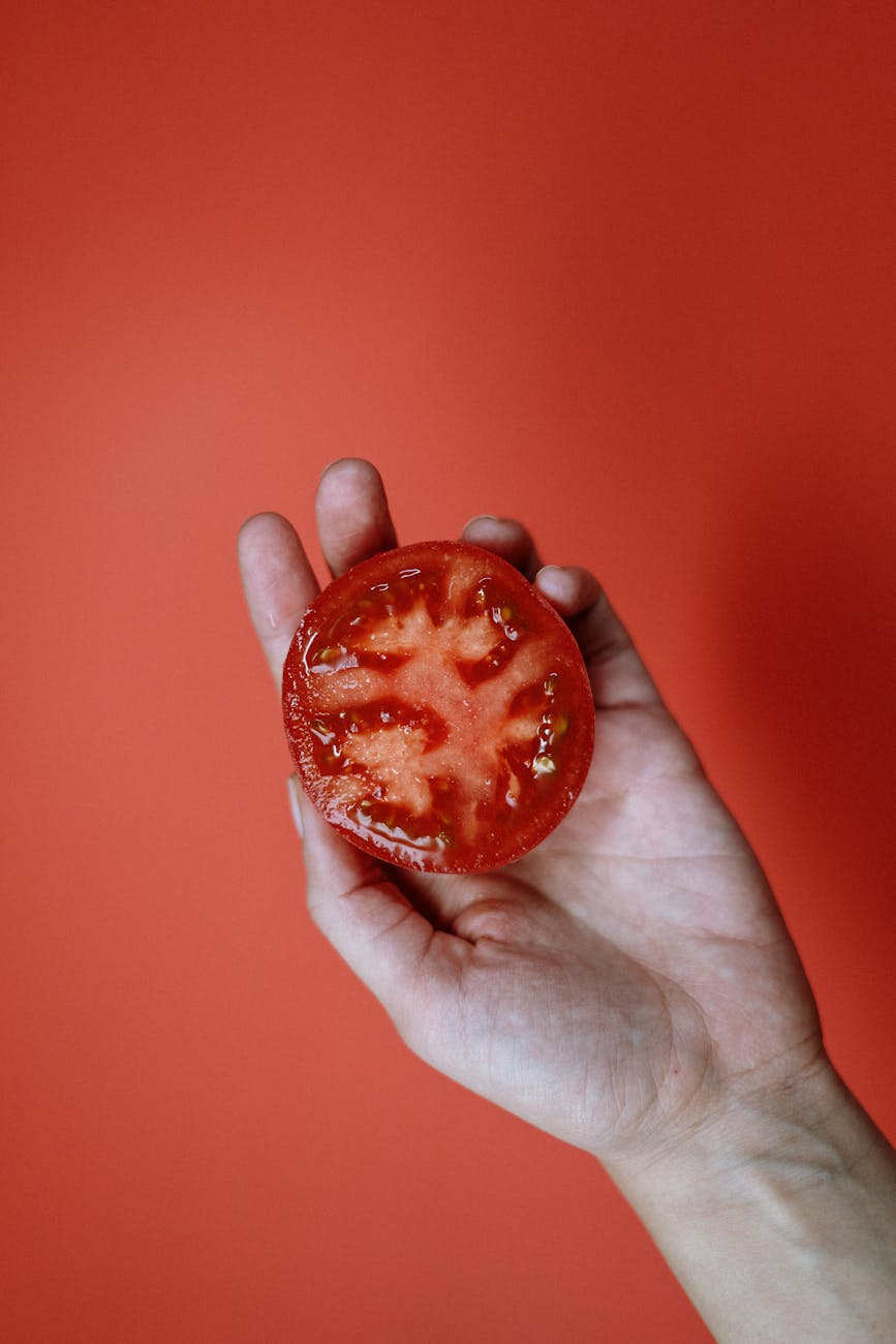 person holding a tomato